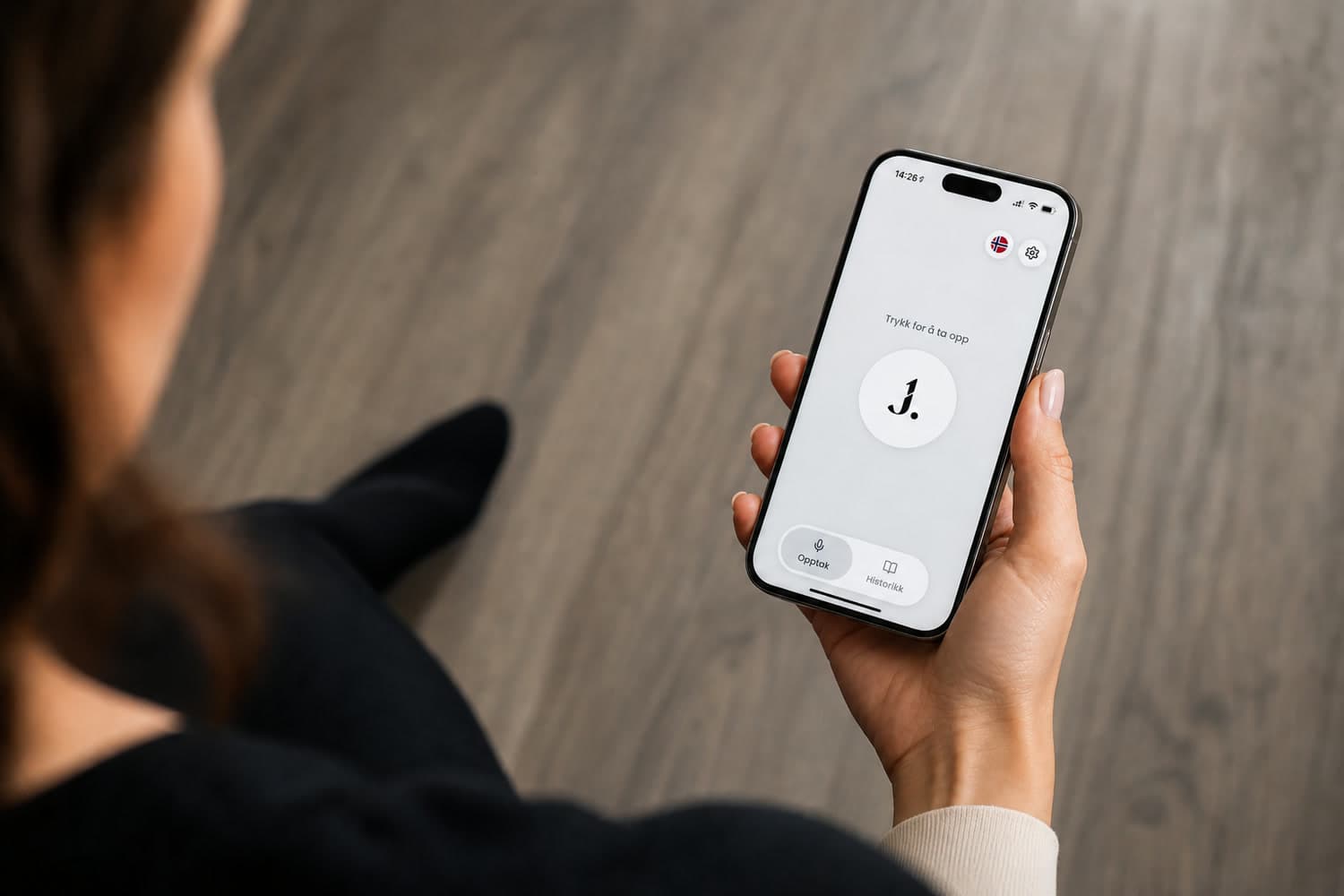A clinician holding a phone with the Journalia app, ready to record a consultation